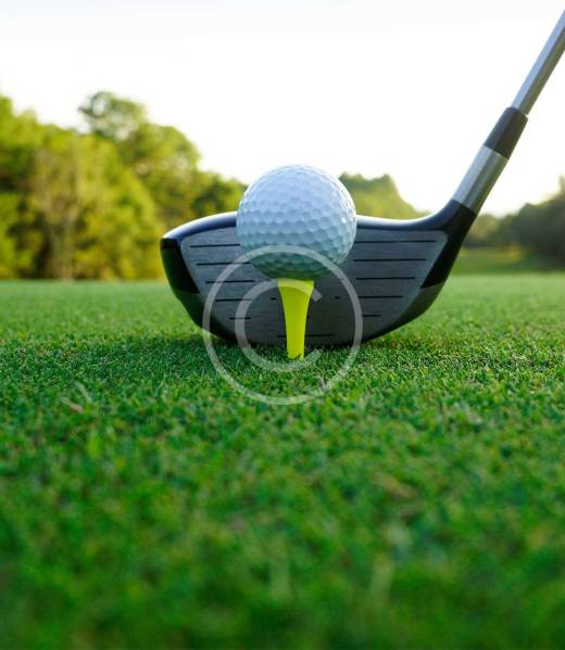 Golf ball and golf club in beautiful golf course at sunset background.